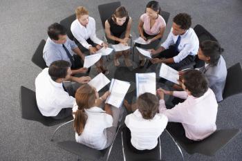 Overhead View Of Businesspeople Seated In Circle At Company Seminar