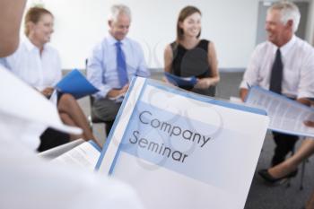 Detail Of Businesspeople Seated In Circle At Company Seminar