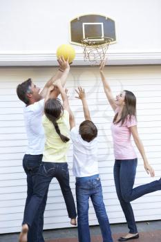 Family Playing Basketball Outside Garage