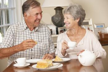 Retired Senior Couple Enjoying Afternoon Tea Together At Home