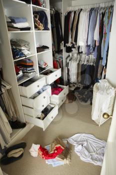 Untidy Teenage Bedroom With Messy Wardrobe