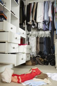 Untidy Teenage Bedroom With Messy Wardrobe