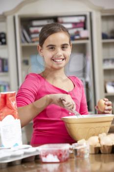 Girl Preparing Ingredients To Bake Cakes In Kitchen