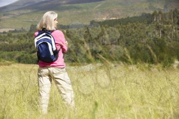 Senior Woman On Hike Through Beautiful Countryside