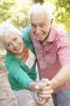 Senior Couple Dancing In Countryside Together