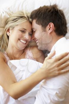 Couple Relaxing In Bed