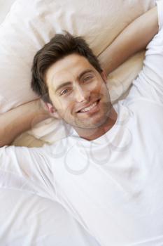 Man Relaxing In Bed