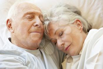 Senior Couple Sleeping In Bed
