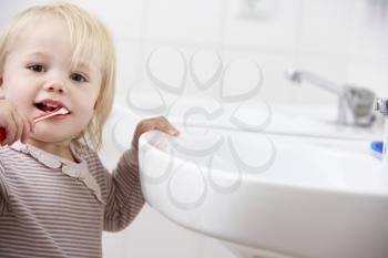 Girl In Bathroom Brushing Teeth