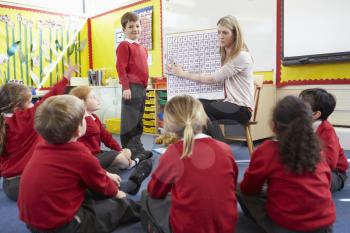 Teacher Teaching Maths To Elementary School Pupils