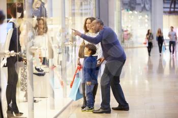 Child On Trip To Shopping Mall With Parents