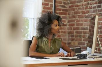 Woman Working At Computer In Contemporary Office