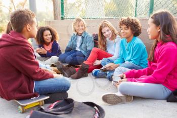 Group Of Young Children Hanging Out In Playground