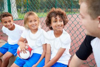 Youth Football Team Training With Coach