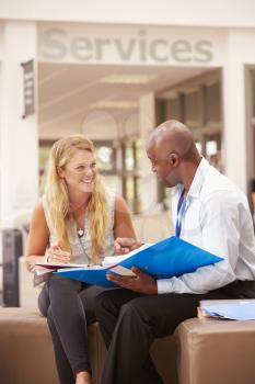 College Student Having Meeting With Tutor To Discuss Work