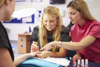 Teacher Helping Students Training To Become Beauticians