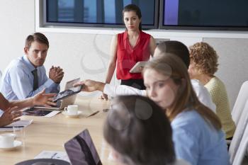 Group Of Businesspeople Meeting Around Boardroom Table
