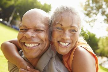 Portrait Of Romantic Senior Couple Relaxing In Park