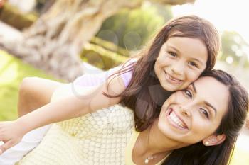 Portrait Of Hispanic Mother And Daughter In Park