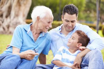 Grandfather With Grandson And Father In Park