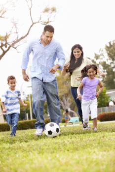 Hispanic Family Playing Soccer Together