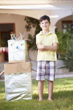 Boy Standing In Garden With Homemade Robot