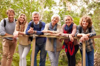 Multi-generation family on a bridge in forest, portrait