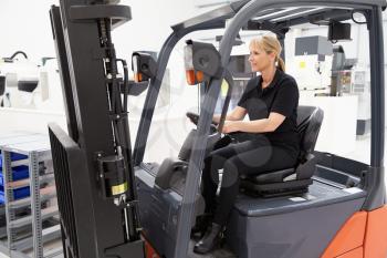 Female Fork Lift Truck Driver Working In Factory