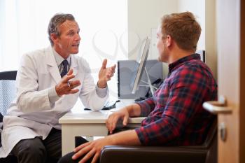 Patient Having Consultation With Male Doctor In Office
