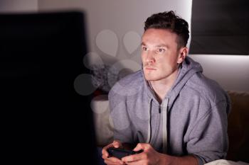 Young Man Addicted To Video Gaming At Home