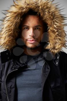 Studio Portrait Of Young Man Wearing Winter Coat