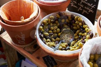 Selection Of Back And Green Olives In Wooden Basket