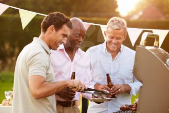 Mature Male Friends Enjoying Outdoor Summer Barbeque