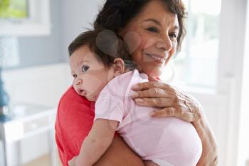 Proud Grandmother Holding Baby Granddaughter