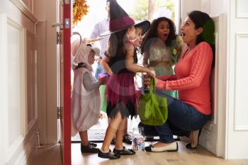 Children In Halloween Costumes Trick Or Treating