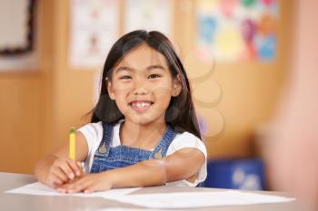 Portrait of a girl at elementary school sitting in classroom