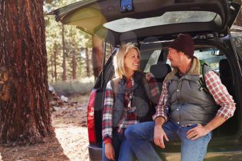 Portrait of a couple by their car before hiking, copy space