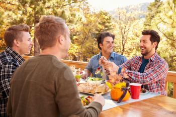 Group Of Gay Male Friends Enjoying Outdoor Meal Together