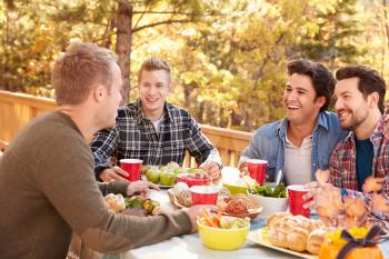 Group Of Gay Male Friends Enjoying Outdoor Meal Together
