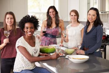 Portrait Of Female Friends Enjoying Pre Dinner Drinks