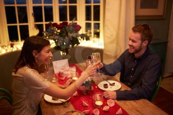 Romantic Couple Make A Toast At Valentines Day Meal