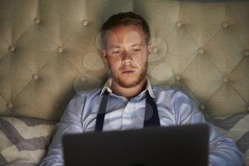Businessman At Home On Bed Working Late On Laptop