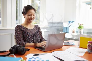 Photographer Working At Laptop In Home Office