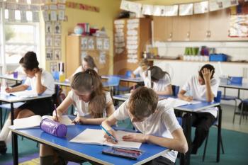 Class of primary school kids studying in a classroom