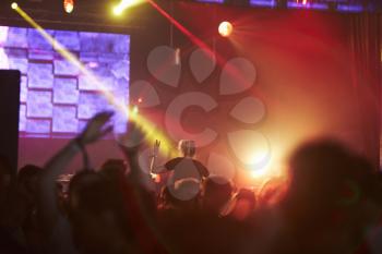 Woman Sitting On Friend's Shoulders At Music Festival