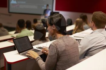 Adult student using laptop computer at a university lecture