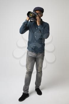 Studio Portrait Of Male Photographer With Camera