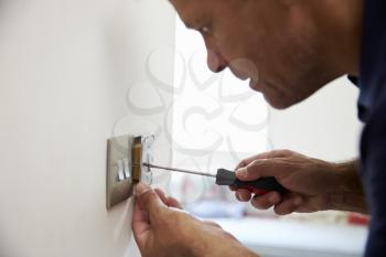 Electrician Repairing Domestic Light Switch