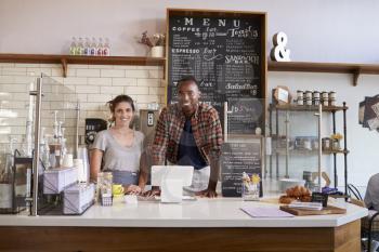 Mixed race couple waiting behind counter at a coffee shop