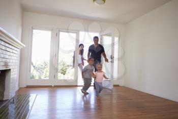 Excited Family Explore New Home On Moving Day